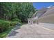Home exterior featuring neutral siding and landscaping, including a large concrete patio at 985 Laurel Springs Ln, Marietta, GA 30064