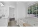 Bathroom featuring soaking tub and walk-in closet at 985 Laurel Springs Ln, Marietta, GA 30064