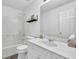 Bathroom featuring a shower and tub, a large vanity, and a framed mirror, offering a clean design at 985 Laurel Springs Ln, Marietta, GA 30064