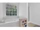 Clean bathroom featuring a soaking tub with a large window at 985 Laurel Springs Ln, Marietta, GA 30064