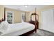 Bedroom with neutral walls, ceiling fan, carpet, large windows, dresser with mirror, and closet for ample storage at 985 Laurel Springs Ln, Marietta, GA 30064