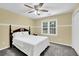 Bedroom with a ceiling fan, neutral walls, large double windows, and closet for ample storage at 985 Laurel Springs Ln, Marietta, GA 30064