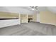 Bonus room featuring neutral paint, carpet, ceiling fan, and built-in shelving and desk work spaces at 985 Laurel Springs Ln, Marietta, GA 30064