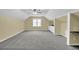 Bonus room featuring neutral paint, carpet, ceiling fan, and built-in shelving and desk work spaces at 985 Laurel Springs Ln, Marietta, GA 30064