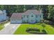 Stunning two-story home featuring a three-car garage, well-manicured lawn, and a charming, symmetrical facade at 985 Laurel Springs Ln, Marietta, GA 30064