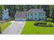 Attractive two-story home with a three-car garage and a well-maintained lawn, surrounded by mature trees at 985 Laurel Springs Ln, Marietta, GA 30064
