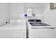 Bright laundry room with Samsung washer, dryer and wire shelving at 985 Laurel Springs Ln, Marietta, GA 30064