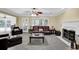Comfortable living room with fireplace, ceiling fan, and comfortable seating overlooking the porch at 985 Laurel Springs Ln, Marietta, GA 30064