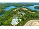 An aerial view of the resort-style pool and tennis courts surrounded by nature and lake views at 1049 Pine Bark Lane, Canton, GA 30114