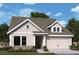Charming single-story home with a two-car garage, complemented by lush landscaping and beautiful flowerbeds at 1049 Pine Bark Lane, Canton, GA 30114