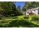 Grassy backyard with mature landscaping and a deck, perfect for outdoor entertaining at 1268 Thomas Rd, Decatur, GA 30030