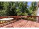 A backyard patio with built in bench seating surrounded by a forest at 1268 Thomas Rd, Decatur, GA 30030