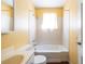 Neutral bathroom featuring a shower and bath with a light-filled window at 1268 Thomas Rd, Decatur, GA 30030