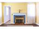 Beautiful yellow fireplace with a blue tile accent at 1268 Thomas Rd, Decatur, GA 30030