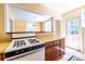 The kitchen has yellow countertops, with view of dining area at 1268 Thomas Rd, Decatur, GA 30030