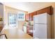 Kitchen featuring a back door with view of deck and stainless steel refrigerator at 1268 Thomas Rd, Decatur, GA 30030