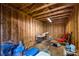 Inside of a storage shed with plywood walls and rafters, filled with furniture and storage containers at 1268 Thomas Rd, Decatur, GA 30030