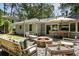 The backyard has a stone patio, fire pit, string lights, and ample seating at 2164 Medfield Trl, Atlanta, GA 30345