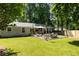 Spacious backyard featuring a large green lawn, patio area, and privacy fence at 2164 Medfield Trl, Atlanta, GA 30345