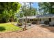 A spacious backyard featuring a stone patio, fire pit, string lights, and lush surroundings at 2164 Medfield Trl, Atlanta, GA 30345
