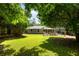 A lush backyard offers a stone patio, seating area, and beautiful green surroundings at 2164 Medfield Trl, Atlanta, GA 30345