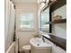 Bathroom featuring vanity sink, updated faucet, and floating wood shelves at 2164 Medfield Trl, Atlanta, GA 30345