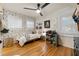 This bedroom features hardwood floors, a ceiling fan, and ample storage space at 2164 Medfield Trl, Atlanta, GA 30345