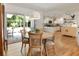 Open floor plan with dining area, wood floors, and kitchen with white cabinetry at 2164 Medfield Trl, Atlanta, GA 30345