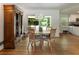 Open floor plan features dining area with wood floors, slider door to backyard, and wooden cabinet at 2164 Medfield Trl, Atlanta, GA 30345