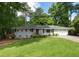Charming single story home with a well manicured front yard, driveway and garage at 2164 Medfield Trl, Atlanta, GA 30345