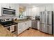 Modern kitchen with stainless steel appliances, granite counters, and ample cabinet space at 2164 Medfield Trl, Atlanta, GA 30345
