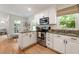 Eat-in kitchen features stainless appliances, granite countertops, and white cabinetry at 2164 Medfield Trl, Atlanta, GA 30345