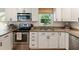 Kitchen features stainless appliances, granite countertops, and white cabinetry at 2164 Medfield Trl, Atlanta, GA 30345