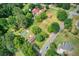 Aerial view of a large lot featuring a home, barn, and a pool, all surrounded by lush greenery at 4545 Gaydon Rd, Powder Springs, GA 30127