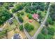 Aerial view showcases multiple homesites, surrounded by lush greenery with a community pool nearby at 4545 Gaydon Rd, Powder Springs, GA 30127