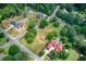 Aerial view showcases multiple homesites and greenery with a community pool nearby at 4545 Gaydon Rd, Powder Springs, GA 30127