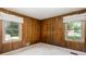 Wood paneled bedroom featuring a window, neutral paint, and carpeted floors at 4545 Gaydon Rd, Powder Springs, GA 30127