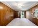 Wood paneled bedroom featuring carpeted floors and a door leading to the backyard at 4545 Gaydon Rd, Powder Springs, GA 30127
