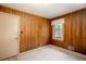 Carpeted bedroom with paneled walls, a window, and a neutral color scheme at 4545 Gaydon Rd, Powder Springs, GA 30127