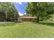 Ranch-style home with mature trees and a covered carport on a spacious lot at 4545 Gaydon Rd, Powder Springs, GA 30127