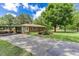 Charming ranch-style home with a brick facade, large front yard, carport, and a long driveway at 4545 Gaydon Rd, Powder Springs, GA 30127