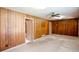 Living room featuring carpet flooring and wood paneled walls at 4545 Gaydon Rd, Powder Springs, GA 30127