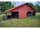 Outbuilding with sliding wood doors, open bays, and secure gated storage areas at 4545 Gaydon Rd, Powder Springs, GA 30127