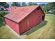 Outbuilding with sliding wood doors and open bays under an expansive roof at 4545 Gaydon Rd, Powder Springs, GA 30127