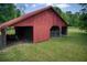 Exterior view of an outbuilding with sliding doors and bays with metal gates at 4545 Gaydon Rd, Powder Springs, GA 30127