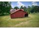 Exterior view of the outbuilding with sliding doors and bays for storage at 4545 Gaydon Rd, Powder Springs, GA 30127