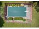 Aerial view showcases a covered backyard pool surrounded by lush landscaping and fencing at 4545 Gaydon Rd, Powder Springs, GA 30127