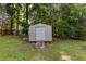 Exterior shot of metal storage shed with a ramp, surrounded by mature trees at 4545 Gaydon Rd, Powder Springs, GA 30127