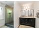 Modern bathroom featuring a glass-enclosed shower and a double vanity with granite countertops at 615 Pinetree Dr, Decatur, GA 30030