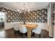 Chic dining room featuring modern wallpaper, light fixtures and table with chairs on hardwood floor at 615 Pinetree Dr, Decatur, GA 30030